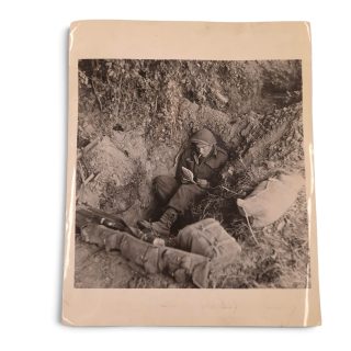 British Press Photograph – Soldier writing from a foxhole, Normandy 1944